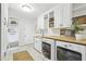 Bright laundry room with washer, dryer, butcher block counters, cabinets and ample storage at 410 Dalrymple Ne Rd, Atlanta, GA 30328
