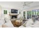 Cozy living room with a stone fireplace, shiplap walls, and sliding glass doors to the deck at 410 Dalrymple Ne Rd, Atlanta, GA 30328