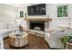 Cozy living room with a stone fireplace, shiplap walls, and large windows offering backyard views at 410 Dalrymple Ne Rd, Atlanta, GA 30328