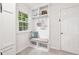 Charming mudroom with a built-in bench, storage shelves, and natural light from the window at 410 Dalrymple Ne Rd, Atlanta, GA 30328