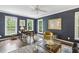 This office features blue walls, hardwood floors, a ceiling fan, and large windows that provide lots of natural light at 410 Dalrymple Ne Rd, Atlanta, GA 30328