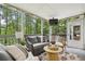 Relaxing screened porch with comfortable seating, views of the woods, and an outdoor TV at 410 Dalrymple Ne Rd, Atlanta, GA 30328
