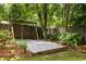 Landscaped backyard featuring a pea gravel area with an archway and privacy fence, perfect for outdoor relaxation at 492 Clifton Ne Rd, Atlanta, GA 30307