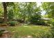 Private backyard featuring mature trees, manicured lawn, and space for outdoor enjoyment and entertaining at 492 Clifton Ne Rd, Atlanta, GA 30307