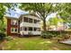 Spacious backyard featuring a two-story screened porch, brick accents, and ample space for outdoor activities at 492 Clifton Ne Rd, Atlanta, GA 30307