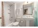 Stylish bathroom featuring a tiled shower, modern fixtures, and a pedestal sink with a decorative mirror at 492 Clifton Ne Rd, Atlanta, GA 30307