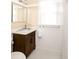 Well-lit bathroom features white wainscoting, a marble vanity, and a framed vanity mirror at 492 Clifton Ne Rd, Atlanta, GA 30307