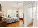 Bright bedroom featuring hardwood floors, a ceiling fan, and a view into a bathroom at 492 Clifton Ne Rd, Atlanta, GA 30307