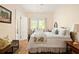 Sunny bedroom featuring a bed with a patterned quilt and a view of the backyard at 492 Clifton Ne Rd, Atlanta, GA 30307
