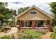 Traditional-style home featuring a welcoming front porch and meticulously maintained landscaping at 492 Clifton Ne Rd, Atlanta, GA 30307