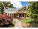 Charming home with brick facade, lovely front porch, and colorful landscaping at 492 Clifton Ne Rd, Atlanta, GA 30307