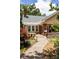 Home with brick accents, inviting front porch, and pathway surrounded by lovely landscaping at 492 Clifton Ne Rd, Atlanta, GA 30307