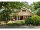 Attractive home with brick details, a cozy front porch, and beautiful natural landscaping at 492 Clifton Ne Rd, Atlanta, GA 30307