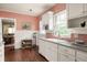 A cozy kitchen with white cabinets and a view into the dining room at 492 Clifton Ne Rd, Atlanta, GA 30307