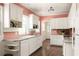 Bright kitchen with white cabinets, stainless steel appliances, and dark hardwood floors at 492 Clifton Ne Rd, Atlanta, GA 30307
