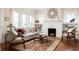 Cozy living room featuring fireplace, built-in bookshelves and large windows at 492 Clifton Ne Rd, Atlanta, GA 30307