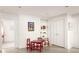 Bright living room featuring white brick walls, built-in shelves, and a cozy table seating area at 492 Clifton Ne Rd, Atlanta, GA 30307