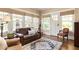 Well-lit living room featuring wood floors, a large area rug, and ample seating at 492 Clifton Ne Rd, Atlanta, GA 30307
