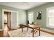 Bright office with pale green walls, hardwood floors, and a large wooden work desk at 492 Clifton Ne Rd, Atlanta, GA 30307