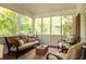 Cozy screened-in porch with a sofa and chairs, perfect for relaxing and entertaining at 492 Clifton Ne Rd, Atlanta, GA 30307