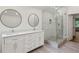 Modern bathroom features double sinks and a frameless glass shower at 51 Queen Anne Se Dr, Mableton, GA 30126