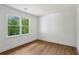 Bedroom with hardwood floors and natural light with green outdoor views at 51 Queen Anne Se Dr, Mableton, GA 30126