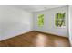 Bedroom features hardwood floors, natural light, and serene outdoor views at 51 Queen Anne Se Dr, Mableton, GA 30126