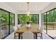 Bright dining room features large windows and a wooden table with seating for six at 51 Queen Anne Se Dr, Mableton, GA 30126
