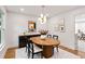 Elegant dining room with modern lighting, stylish decor, neutral colors, and a view into adjacent living areas at 51 Queen Anne Se Dr, Mableton, GA 30126