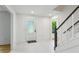 A pristine foyer featuring tile flooring, white walls, and staircase with modern black rails, creating a welcoming entrance at 51 Queen Anne Se Dr, Mableton, GA 30126