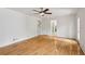 Bright, open-concept living room with hardwood floors and a ceiling fan at 51 Queen Anne Se Dr, Mableton, GA 30126
