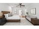 Bright main bedroom features a ceiling fan, seating area, and stylish decor at 51 Queen Anne Se Dr, Mableton, GA 30126