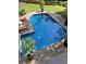 In-ground pool surrounded by a concrete deck, greenery, and comfortable outdoor seating at 51 Queen Anne Se Dr, Mableton, GA 30126