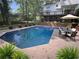 Backyard with an in-ground pool, outdoor seating, and lush landscaping at 51 Queen Anne Se Dr, Mableton, GA 30126