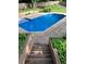 Inviting in-ground pool with blue water, surrounded by concrete deck and lush landscaping at 51 Queen Anne Se Dr, Mableton, GA 30126