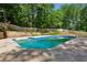 A beautiful in-ground pool with a large concrete deck, perfect for summer relaxation and entertainment at 51 Queen Anne Se Dr, Mableton, GA 30126