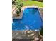 Inviting in-ground pool surrounded by a concrete deck, lush greenery, and potted plants at 51 Queen Anne Se Dr, Mableton, GA 30126