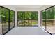 Bright sunroom with large windows offering scenic views of surrounding greenery, seamlessly connecting indoor and outdoor living at 51 Queen Anne Se Dr, Mableton, GA 30126