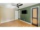 Bedroom with hardwood floors, ceiling fan, and contrasting paint, offering a modern feel at 1652 Oak Grove Rd, Decatur, GA 30033