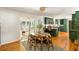 Open dining and kitchen area with hardwood floors, green cabinets, and natural lighting at 1652 Oak Grove Rd, Decatur, GA 30033