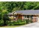Charming brick home with a black fence and well-manicured lawn at 1652 Oak Grove Rd, Decatur, GA 30033