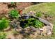 Backyard water feature with small rock waterfall and lily pads at 1652 Oak Grove Rd, Decatur, GA 30033