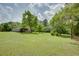 Expansive green backyard with a metal shelter at 203 Leigh Dr, Ellenwood, GA 30294