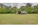 Open green backyard with a metal shelter at 203 Leigh Dr, Ellenwood, GA 30294