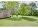Spacious backyard featuring a small wooden shed at 203 Leigh Dr, Ellenwood, GA 30294