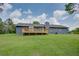 The rear of the home with a large deck and lawn at 203 Leigh Dr, Ellenwood, GA 30294