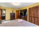Relaxing bedroom showcasing natural light from windows, warm-toned walls, and ample dark-wooden storage space at 203 Leigh Dr, Ellenwood, GA 30294