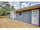 A large wooden deck extends across the back of a blue house at 203 Leigh Dr, Ellenwood, GA 30294