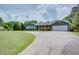 Inviting single-story home features a spacious front yard and convenient driveway at 203 Leigh Dr, Ellenwood, GA 30294