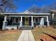 Charming home with a welcoming front porch, pillars, and a bright yellow front door at 455 Lynch Nw Ave, Atlanta, GA 30318